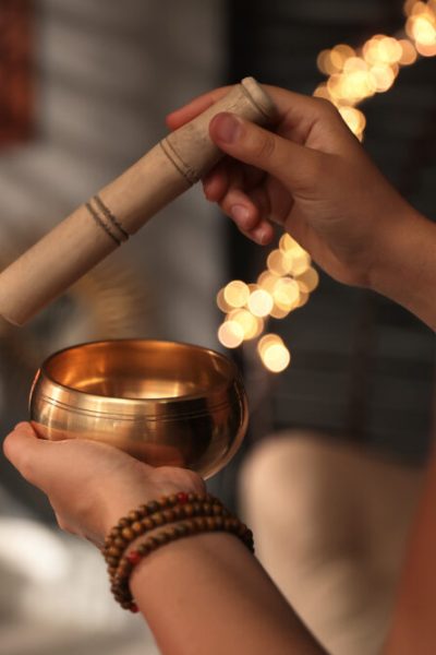 Healer,Using,Singing,Bowl,In,Dark,Room,,Closeup