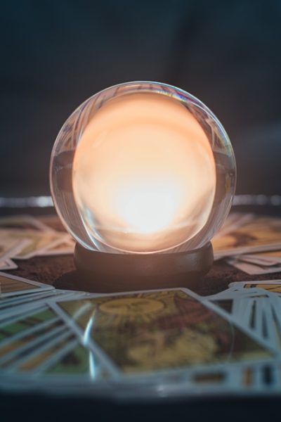 Fortune,Teller,With,Illuminated,Crystal,Ball,And,Tarot,Cards,To